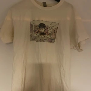 Vit t-shirt med tryck - Säljer en vit t-shirt med ett unikt tryck av en person. Lite Missfärgad runt armhålan.