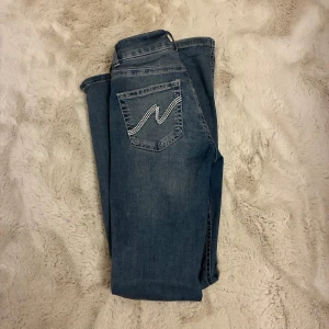Blå bootcut jeans med broderade bakfickor - Säljer dessa populära NELLY jeans. Har använt de 2-3 gånger men tycker inte de passar min stil så hoppas de passar bättre på någon annan💕💕