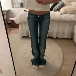 Blå bootcut jeans med låg midja - Säljer ett par trendiga och snygga blå bootcut jeans med låg midja och lätt slitning framtill💕Köpta här på plick men säljer vidare då de inte passade mig.❣️(Bilderna är lånade) 