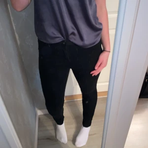 Svarta high rise skinny jeans - Svarta skinny jeans med hög midja från VMD. Byxorna har klassisk femficksdesign och stängs med dragkedja och knapp. Perfekta för dig som gillar en tight passform och stilren look.