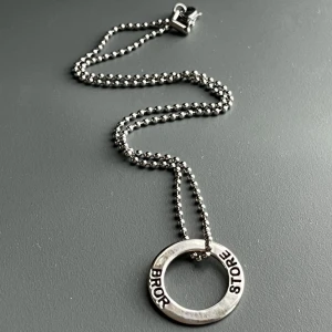 Nytt halsband med 925 sterling silver - stämplat - hänge m texten "Storebror" Butikspris 399 kronor  -  Helt nytt halsband med rund berlock i äkta sterling silver (925), stämplad på baksidan. Text: “STORE BROR” – en fin och personlig present. Hänget är ca 2,5 cm i diameter och hänger på en 42 cm kulkedja i nickelfritt stål.  Ingen prutning, men jag erbjuder bundlerabatt! 