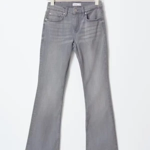 Low waist bootcut jeans - Snygga grå jeans med bootcut passform och klassisk femficksdesign. Jeansen har låg midja och är tillverkade i denim med lätt stretch för extra komfort. Perfekta för dig som gillar en retroinspirerad look.