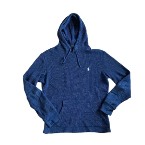Blå hoodie från Polo Ralph Lauren - Str S- Mysig blå hoodie från Polo Ralph Lauren med broderad logga på bröstet. Tröjan är ribbstickad, har huva med snörning och en stor magficka. Perfekt för dig som gillar en avslappnad och stilren look. Långärmad och i mjukt material. Perfekt för hösten som kommer nu! Hör av er om ni har frågor! 