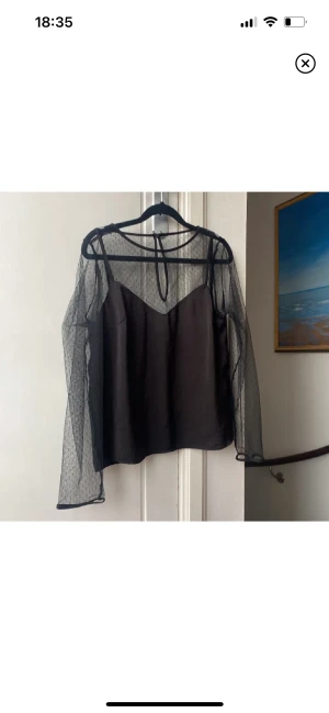 Blus - Blus med mesh armar med prickar. 