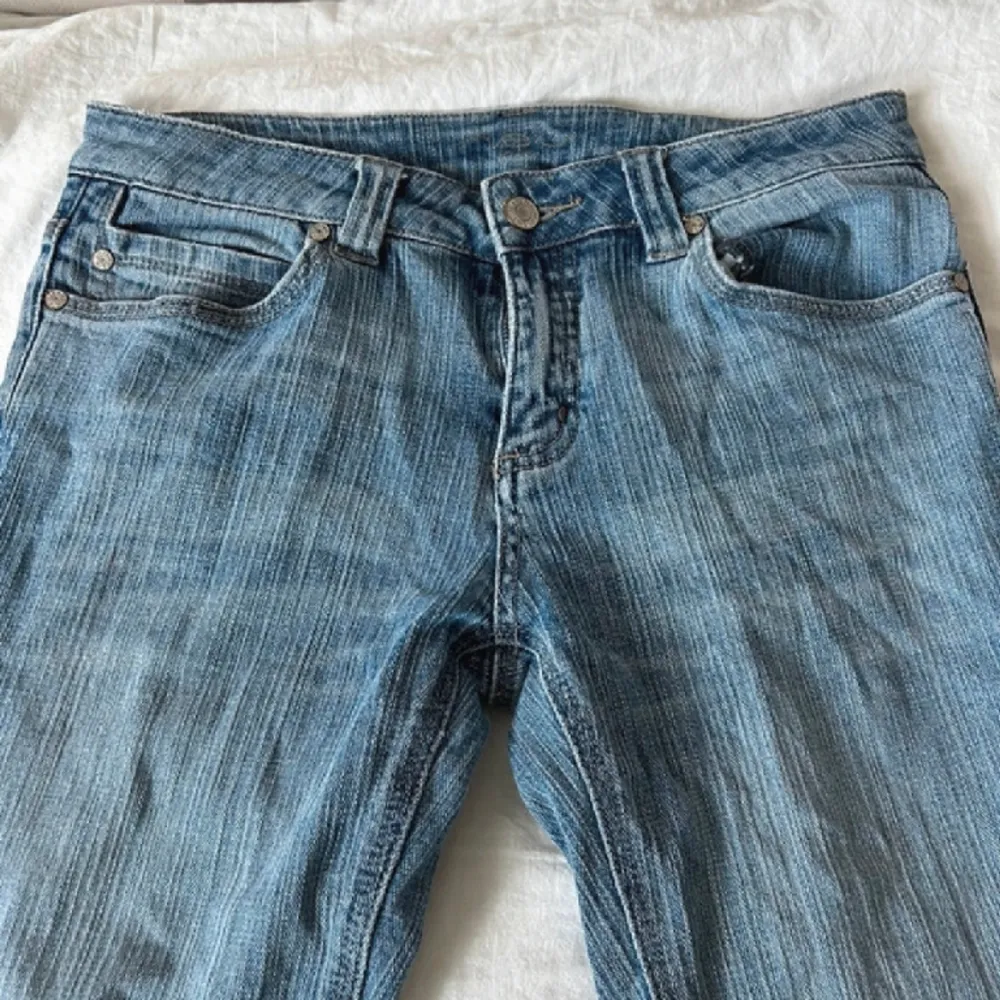 Utsvängda blåa jeans, lågmidjade💕 41 cm i höfter och 77 cm i innerbenet☺️ De är i ett mycket bra sick. de var lite kortare än vad jag hade önskat, det är derför jag säljer dem❤️Bilden är dålig för byxorna är randiga i motivet!. Jeans & Byxor.