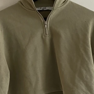 Croppad collegetröja med dragkedja  - NY! Croppad collegetröja i storlek XS. Olivgrön färg. Hög krage och dragkedja. Aldrig använd, saknar dock taggar 