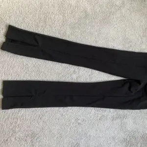 Svarta tajta byxor med slits, använda 1 gång. Säljer då de är för små
