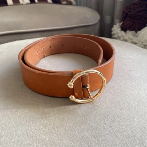 Fint skärp - Fint brunt skärp med gulddetaljer Storlek s. Lite nött men i övrigt fint