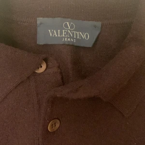 Valentino Button up - Valentino tröja i asbra skick, skulle nästan säga 10/10. Kvaliten på bilderna blev sämst men för att se den vinröda färgen bättre kolla sista bild eller hör av dig för fler bilder. Kan även passa L.  Tröjan är i merinowool.
