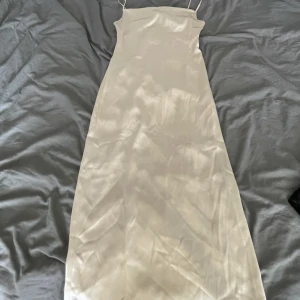 Guld midi-klänning  - Guldfärgad midi klänning som på utsidan känns typ som satin. Den kommer från märket Aéryne och är i storlek M. Den har nästan aldrig använts. Nypris 1500kr