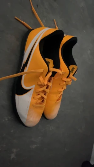 Nike Inomhus skor  - aldrig använt dem, utmärkt matrial.   Namne: Skor Vapor 13 Club Ic AT7997 801 Laser Orange/Black/White