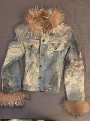 Pälsjeansjacka - Otroligt speciell jacka.  Köpt i Thailand av en ung tjej som hade en egen thriftbuisness där hon handplockade och designade om plaggen. Äkta päls. Tunn jacka. Strlk S. Skiftande i färgerna, men som ett urtvättat jeanstyg.  One of a kind! 