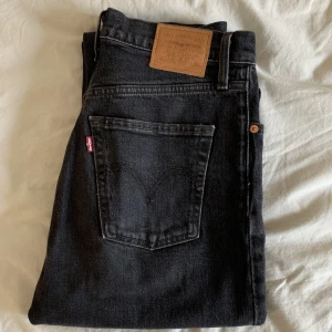 Svarta Levis  - Svarta Levis jeans i modell ribbcage. Måttligt använda, men inget synligt slitage.