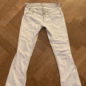 Lågmidjade jeans från lee - vita/jätte ljusblåa lågmidjade Bootcut jeans från Lee🤗innerbenslängden är 80cm och midjan är 36 cm. Lite för korta på mig som är 173. De är lite trasiga vid midjan vilket syns på sista bilden. Skriv vid frågor eller fler bilder 