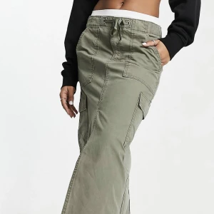 Lågmidjad lång cargokjol - En helt oanvänd Långkjol i cargo material och sil. Köpt på asos och glömt lämna tillbaka så lappar finns kvar!  