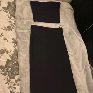 Svart glittrig klänning  - En glittrig svart klänning med 2 delar i storlek XS.  Har aldrig använt dom bara testat när jag köpte den. Är från Ginatricot. Original pris  Toppen 199kr  Kjolen 499kr  Nytt pris  Toppen 120kr  Kjolen 440kr