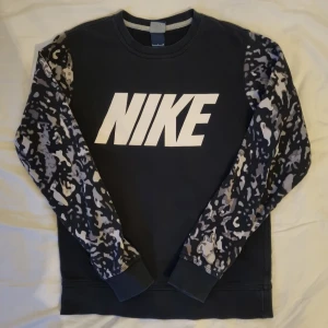 Nike sweatshirt - Blågrå Nike-sweater med grå kamouflage. Jättefint skick! Herrstorlek S. Passar dam med M. Kontakta mig för fler bilder. 
