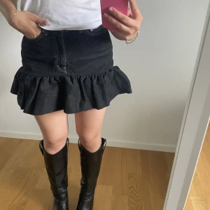 Jeanskjol med volang  - Svart jeanskjol med volang och vita sömmar, sytt om från jeans till jeanskjol, jeansen är från weekday och har storlek 28 i midjan🩶🖤