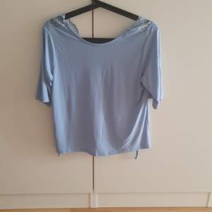 Blue top with laced open back size small, from ginatricot