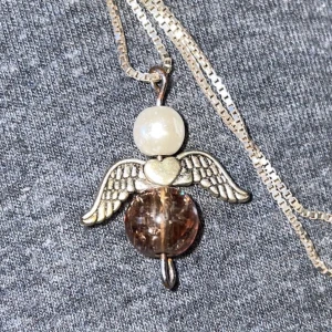 Skyddsängel  - En sjukt söt skyddsängel med brun pärla! Köparen står för frakten❤️ kjedjan åtföljer inte med