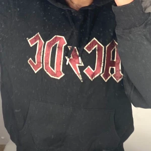 ACDC Hoodie Svart - XS/S - Använd 2-3 ggr. Lite svart/gråaktig med text både fram och bak. Skön luva och inte så tjock i materialet. 