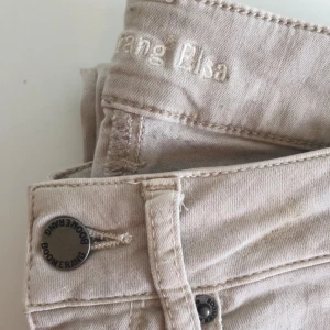  - Elsa Stretch Twill från Boomerang 
Färg: Beige
Stl: 25/32 (är väldigt stretchiga dock) 
65,5% bomull
31% polyester 
3,5% lycra

Finns i Stockholm