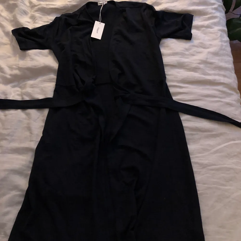 En helt oanvänd svart omlottklänning från Filippa K. Strl XS, skriv för mer info! . Klänningar.