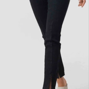  - Svarta jeans från Nakd med slits nedtill, aldrig använda, storlek 36!