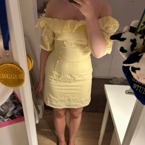 Gul offshoulder kortklänning med volang - Söt ljusgul kortklänning med offshoulder och volangdetalj upptill. Super fin till sommaren och använd fåtal gånger!💛funkar 36/38