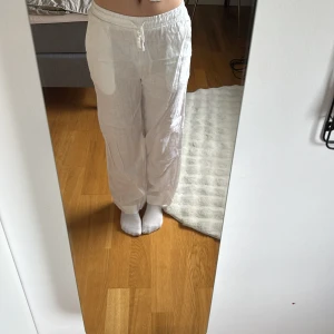 Vita linnebyxor med resårmidja - Säljer ett par vita linnebyxor från Cubus i storlek XS. Byxorna har resår i midjan, raka ben och sidfickor. Använda 2 ggr. Perfekta för varma dagar och har en avslappnad passform.