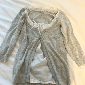 Ljusgrå vintage kofta med spetsdetaljer - Söt ljus grå kofta som sitter fast med en vit spets blus under☀️märker är kookaii och den är i storlek s/m! Använd köp nu funktionen❤️