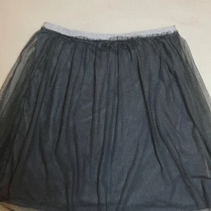 Grå tyllkjol från H&M🩶 - Säljer en grå tyllkjol från H&M med elastisk midja. Kjolen har ett lager tunn tyll som ger en luftig och voluminös känsla. Perfekt för dig som vill ha en enkel men snygg kjol med lite extra volym. Pris kan såklart diskuteras🤍passar xs och xxs 