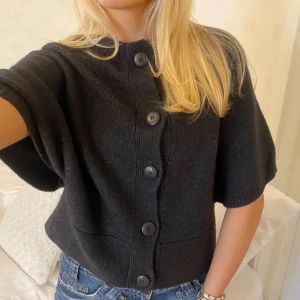 Svart kortärmad kofta med knappar - Älskar den här koftan så himla fin och mysig! Säljer för att jag rensar min garderob 🩷