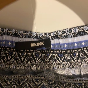 Mönstrade byxor från Bik Bok - Snygga mönstrade byxor från Bik Bok i svart, blått och vitt. Byxorna har ett bohemiskt mönster och en bekväm passform med resår i midjan. Perfekta för en avslappnad stil.