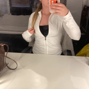 Vit tränings tröja från Nelly - Säljer denna trendiga tränings tröja ifrån Nelly. Använd endast en gång! Den är i storlek L men passar även M och en stötte S