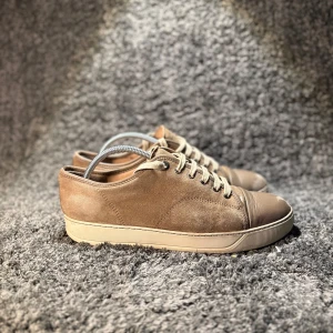 Lanvin skor  - 🌟Säljer ett par bruna sneakers från Lanvin med ovandel i mocka och tåparti i skinn. Skorna har beige snörning och platt sula. Kommer med originalkartong och dustbags.🌟kom privat för en extra deffekt! kvitto från NK 2020 , Simons Garderob 