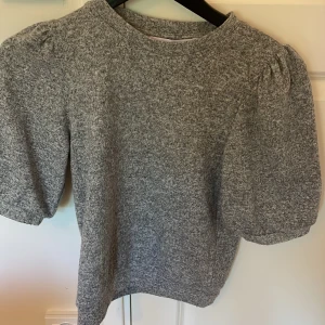 Grå puffärm stickad tröja - Jätte fin grå tröja. Ärmarna är mellan t-shift och långärmad. Från lager 157