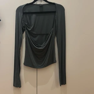 Grön topp från Gina Tricot - Säljer den här gröna långärmade toppen i storlek M från Gina Tricot då den inte kommer till användning. Använd ett fåtal gånger. 