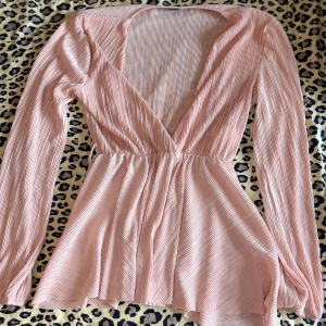 Ljusrosa omlottblus - Supersöt ljusrosa omlottblus med djup v-ringning. Köpt second hand men endast använd 1 gång av mig!🫶🏼