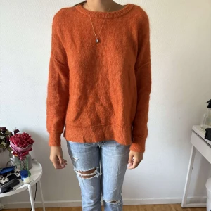 Orange stickad mohair tröja i loose fit - Mysig orange stickad mohair tröja med rund halsringning och ribbade muddar. Tröjan har en avslappnad, loose passform och långa ärmar, enkel och stilren design som är lätt att matcha med jeans eller kjol!🌸🌸