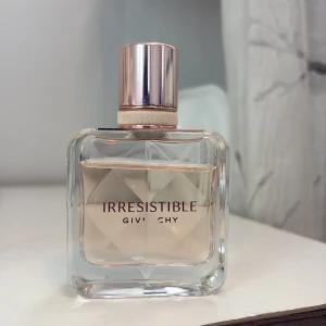 Givenchy Irresistible parfym 35ml - Givenchy Irresistible parfym i en lyxig, fyrkantig glasflaska med roséguldfärgat lock och detaljer. Doften har en ljusrosa ton och flaskan rymmer 35 ml. Perfekt för dig som gillar eleganta och moderna dofter.
