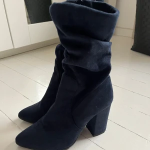 Mörkblå mockastövletter med klack - Säljer ett par mörkblå stövletter i mocka med hög klack och spetsig tå. Skorna har en slouchy design och dragkedja på insidan för enkel påtagning. Perfekta för att lyfta din outfit med en trendig touch. Knappt använda. Skriv för fler bilder💙