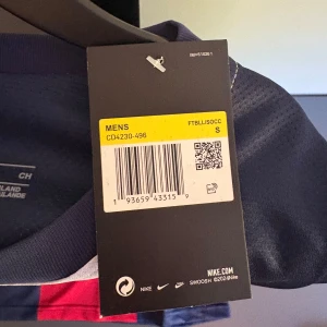 Paris Saint-Germain fotbollströja Nike - Säljer en blå Paris Saint-Germain fotbollströja från Nike med Fly Emirates-tryck på bröstet och klubbmärke. Tröjan har korta ärmar, vitt och rött mönster framtill samt Nike-logga. Perfekt för fans av PSG. Helt ny aldrig använt påse tillkommer tveka inte på att höra av er😀