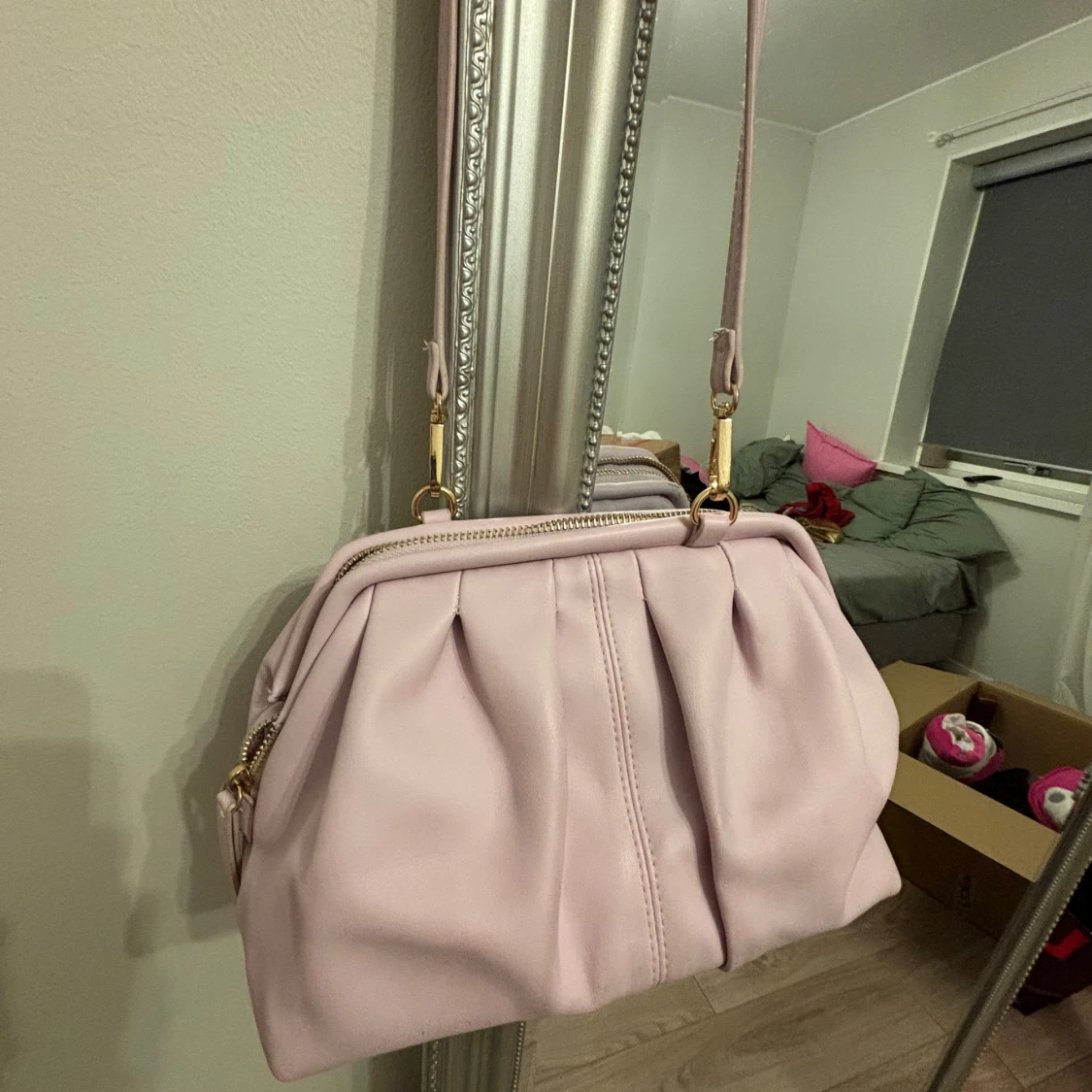 Ljusrosa axelväska med gulddetaljer