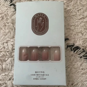 Falska naglar i nude ombre - Snygga lösnaglar i nude ombre med naturlig glansig finish. Kommer i en stilren ljusblå förpackning med fönster som visar naglarna. Tillverkade i ABS-plast och passar dig som vill ha en enkel men elegant look.