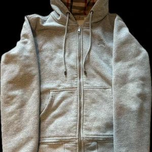 Grå hoodie från Burberry - Säljer en stilren grå hoodie från Burberry, tröjan passar S-M och är i mycket bra skick 