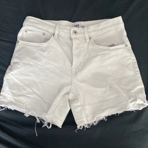 Vita jeansshorts från lager 157 - Snygga vita jeansshorts från lager 157 i storlek S. Modellen är högmidjad med klassiska fem fickor, knappgylf och bälteshällor. Shortsen har rå, fransig kant nedtill för en chill vibe. Perfekta till sommaren och lätta att matcha med allt.
