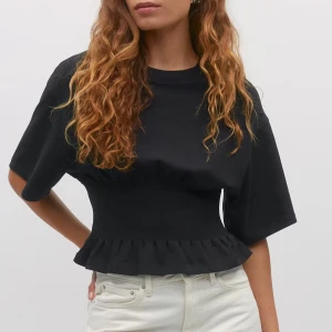 Svart topp med volangdetalj - Snygg svart topp med volangdetalj i midjan. Verkligen skitsnygg!!  Köpte förra veckan och endast testad en gång då jag kände att den inte passade mig riktigt💞skriv för fler bilder och frågor! 