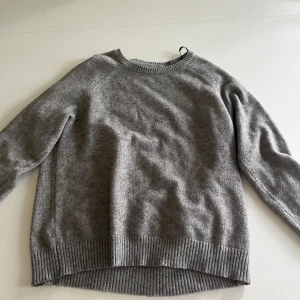 Grå stickad tröja från ONLY - Mysig grå stickad tröja från ONLY i storlek S. Tröjan har rund halsringning, långa ärmar och breda ribbade muddar vid ärmslut. Köpt för flera år sedan, använd men inga defekter🩷 