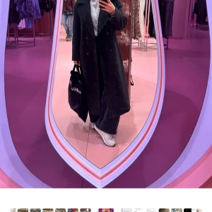 Mörkgrå kappa - Elegant svart kappa med dubbelknäppning och klassisk krage. Perfekt för kyligare dagar med sin långa design och stilrena look. Passar bra till både vardag och mer uppklädda tillfällen. Något oversize 